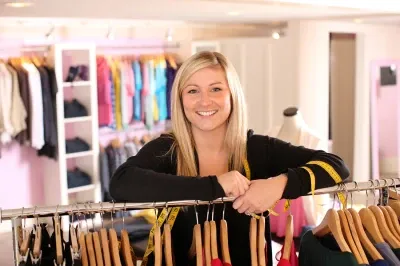 Woman leaning over clothes rack
